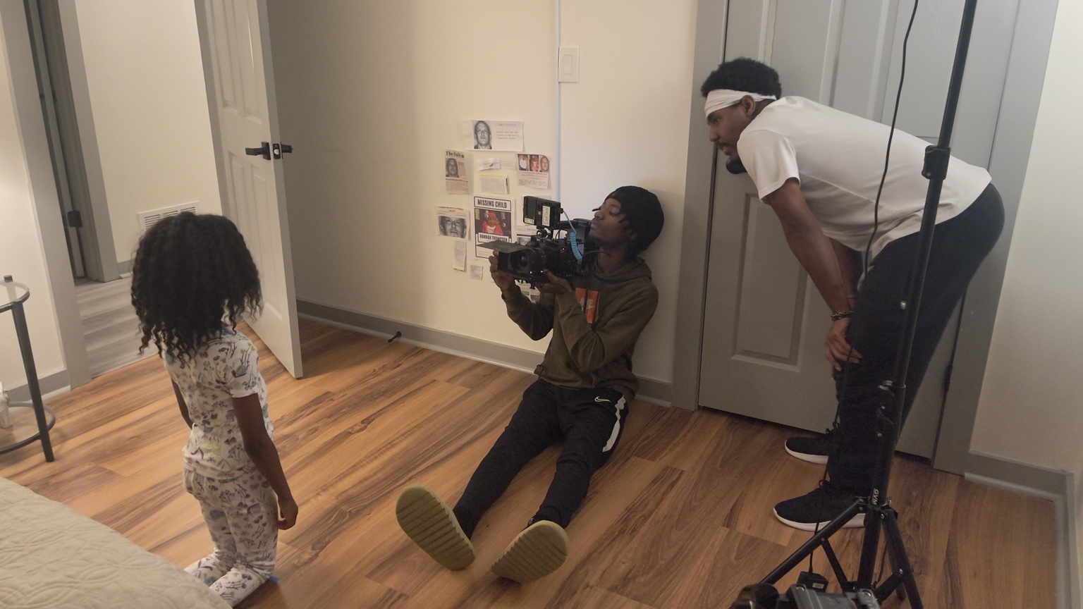Camera crew films from the floor near a child performer.